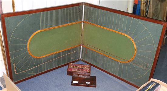 An old racing game with board together with lead horses, jockeys and fencing